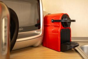 a red suitcase sitting next to a microwave at Apartment Maya - Tremezzina in Tremezzo +15 photos