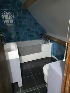 a bathroom with a bath tub and a toilet at Lamb Cottage Bed and Breakfast in Box +38 photos