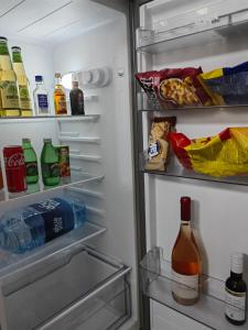 an open refrigerator filled with food and drinks at Apartmani B&R in Lazarevac +10 photos