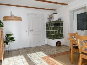 a living room with a door and a dog in a room at Ferienwohnungen Geier in Niederalteich +46 photos
