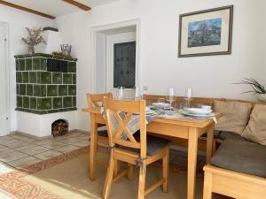 a dining room with a table and a couch at Ferienwohnungen Geier in Niederalteich