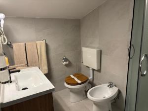 a bathroom with a toilet and a sink at Rooms Marko Polo in Zadar