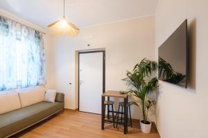 a living room with a couch and a table at Gioia apartment in Sabaudia