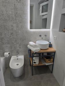 a bathroom with a sink and a toilet and a mirror at Sole e Sale in Terracina