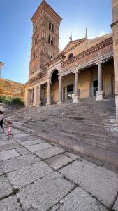 a large building with a clock tower and stairs at Sole e Sale in Terracina