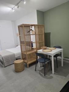 a room with a table and chairs and a bed at Sole e Sale in Terracina