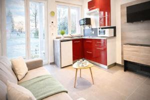 a living room with a couch and a kitchen at studio tout équipé, calme avec terrasse et parking in Audincourt