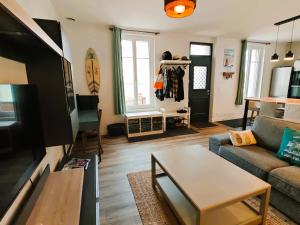 a living room with a couch and a table at La Grande Mimi in Jard-sur-Mer