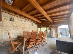 a dining room with a wooden table and chairs at La Grande Mimi in Jard-sur-Mer