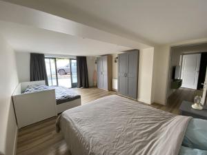 a bedroom with a large bed and a large window at La Grande Mimi in Jard-sur-Mer