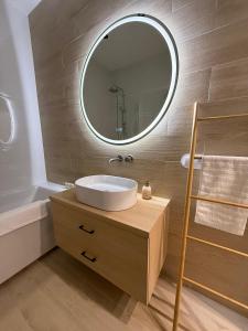 a bathroom with a sink and a mirror at BONA Apartment in Świecie +6 photos