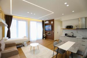 a large living room with a kitchen and a living room at La Dimora Azzurra in Vlorë
