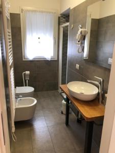 a bathroom with a sink and a tub and a toilet at Alloggi Al Melograno in Marcon