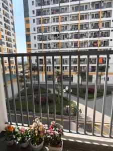 a balcony with potted plants and a building at Mochi Home in An Dương