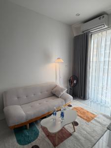 a living room with a couch and a table at Mochi Home in An Dương