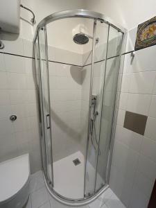 a glass shower in a bathroom with a toilet at Balcone sulle Meraviglie in Urbino +13 photos
