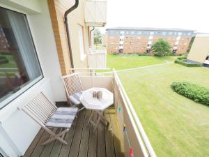 a balcony with two chairs and a table and a window at App 12-A67 in Westerland