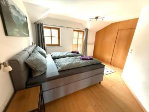 a living room with a couch with pillows on it at Ferienwohnung Leitacker im Kaiserwinkl in Rettenschöss