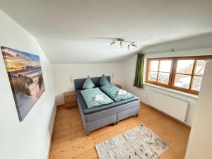 a living room with a couch and a window at Ferienwohnung Leitacker im Kaiserwinkl in Rettenschöss