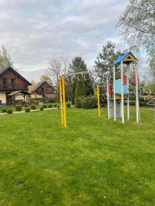 a park with a playground with a slide at Domki Florentyna Szklarska Poręba-Wojcieszyce in Wojcieszyce