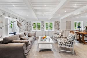 a living room with a couch and a table at Carolinen Hof 1 in Tinnum