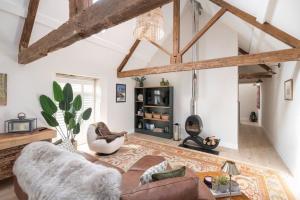 a living room with a couch and a table at The Foaling Box at Lanhill in Oakhill