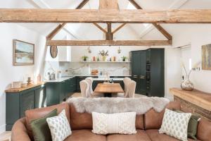 a living room with a couch and a table at The Foaling Box at Lanhill in Oakhill