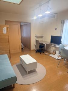 a living room with a table and a desk at pier21 in Hakodate