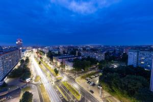 an aerial view of a city at night at Kaleo apartments - Hanza Tower in Szczecin