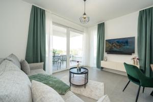 a living room with a couch and a table at Apartments Olive Gardens 2 in Novalja