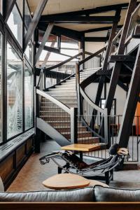 a spiral staircase in a room with a couch at La Cachette, Friendly Hotel & Spa in Arc 1600 +104 photos