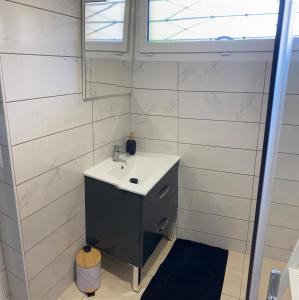 a bathroom with a sink and a mirror at Petite maison de village in Ancerville +18 photos