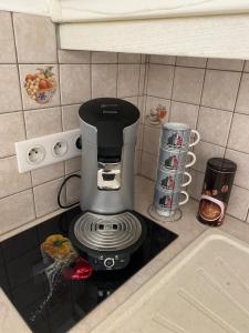 a coffee maker sitting on top of a kitchen counter at Petite maison de village in Ancerville
