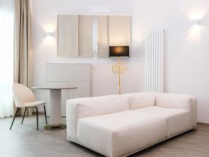 a living room with a white couch and a table at Bellavista Terme Resort & Spa in Montegrotto Terme
