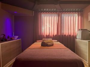 a bedroom with a large bed with a microwave on it at Dolomites Base Camp Hotel Olympia in Arabba