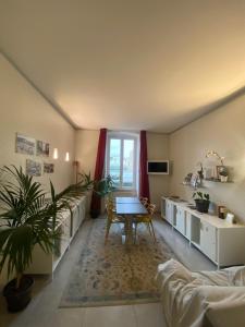 a living room with two beds and a table at 54 ROSSELLI ROOMS in La Spezia