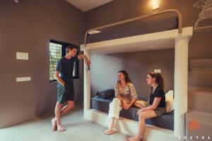 a group of three people sitting on a bunk bed at Zostel Hampi, Gangavathi in Hampi