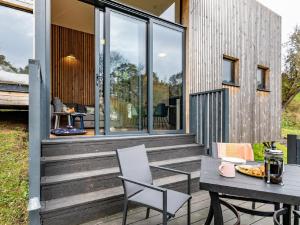 a house with a wooden deck with a table and chairs at 2 Bed in Brecon oc-59734 in Talgarth