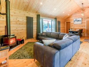 a living room with a couch and a fireplace at 3 Bed in Cullompton oc-96118 in Willand