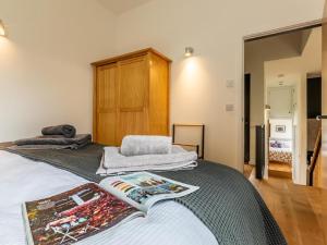 a bedroom with a bed with a book on it at 2 Bed in Brecon oc-59734 in Talgarth