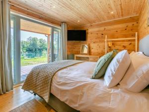 a bedroom with a bed and a large window at 3 Bed in Cullompton oc-96118 in Willand +21 photos
