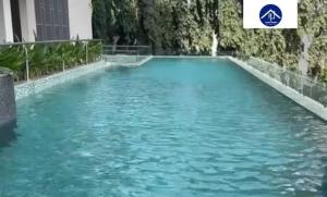 a pool of blue water in a building at FOREL RESIDENCE Jc in Accra
