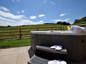 a hot dog on a grill with a field in the background at 1 Bed in Hereford oc-78641 in Callow +6 photos