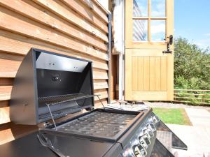 a laptop computer sitting on top of a grill at 1 Bed in Hereford oc-78641 in Callow