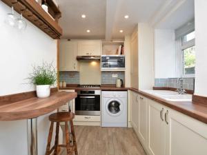 a kitchen with white cabinets and a sink and a dishwasher at 2 Bed in High Peak oc-57871 in Hayfield