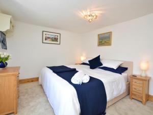 a bedroom with a bed with two towels on it at 2 Bed in High Peak oc-57871 in Hayfield