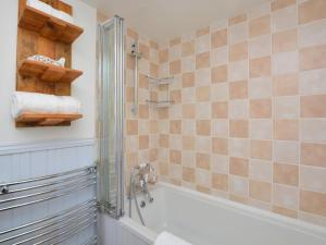 a bathroom with a shower and a bath tub at 2 Bed in High Peak oc-57871 in Hayfield +12 photos
