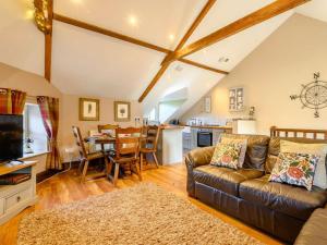 a living room with a couch and a table at 2 Bed in Crickhowell oc-90346 in Crickhowell