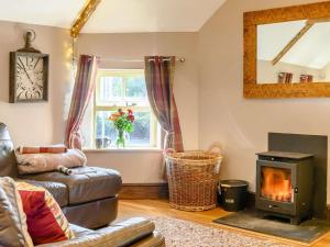 a living room with a couch and a stove at 2 Bed in Crickhowell oc-90346 in Crickhowell
