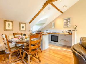a kitchen and dining room with a table and chairs at 2 Bed in Crickhowell oc-90346 in Crickhowell +13 photos